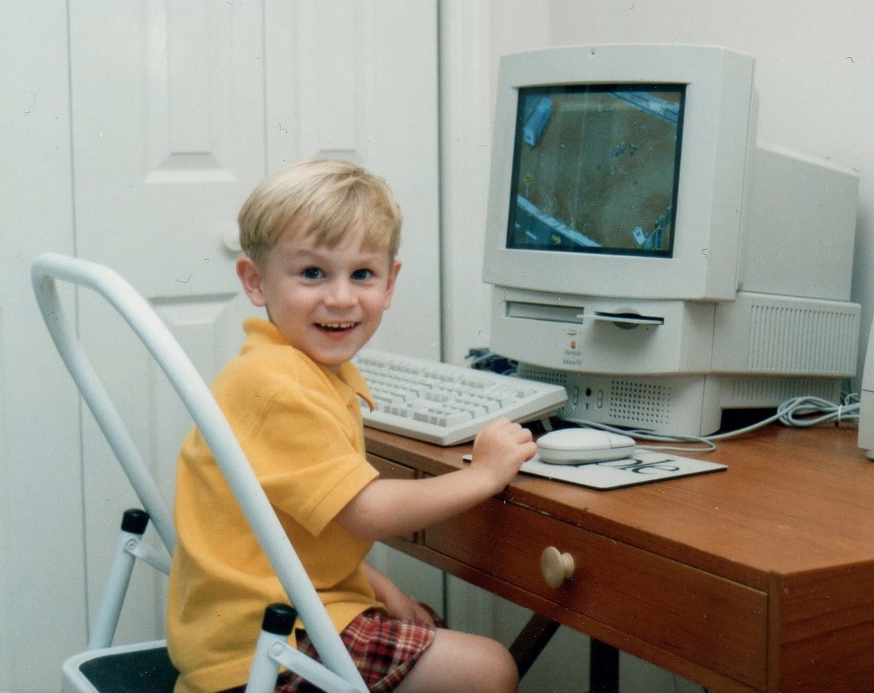 A young Chris Caruso at a Macintosh.